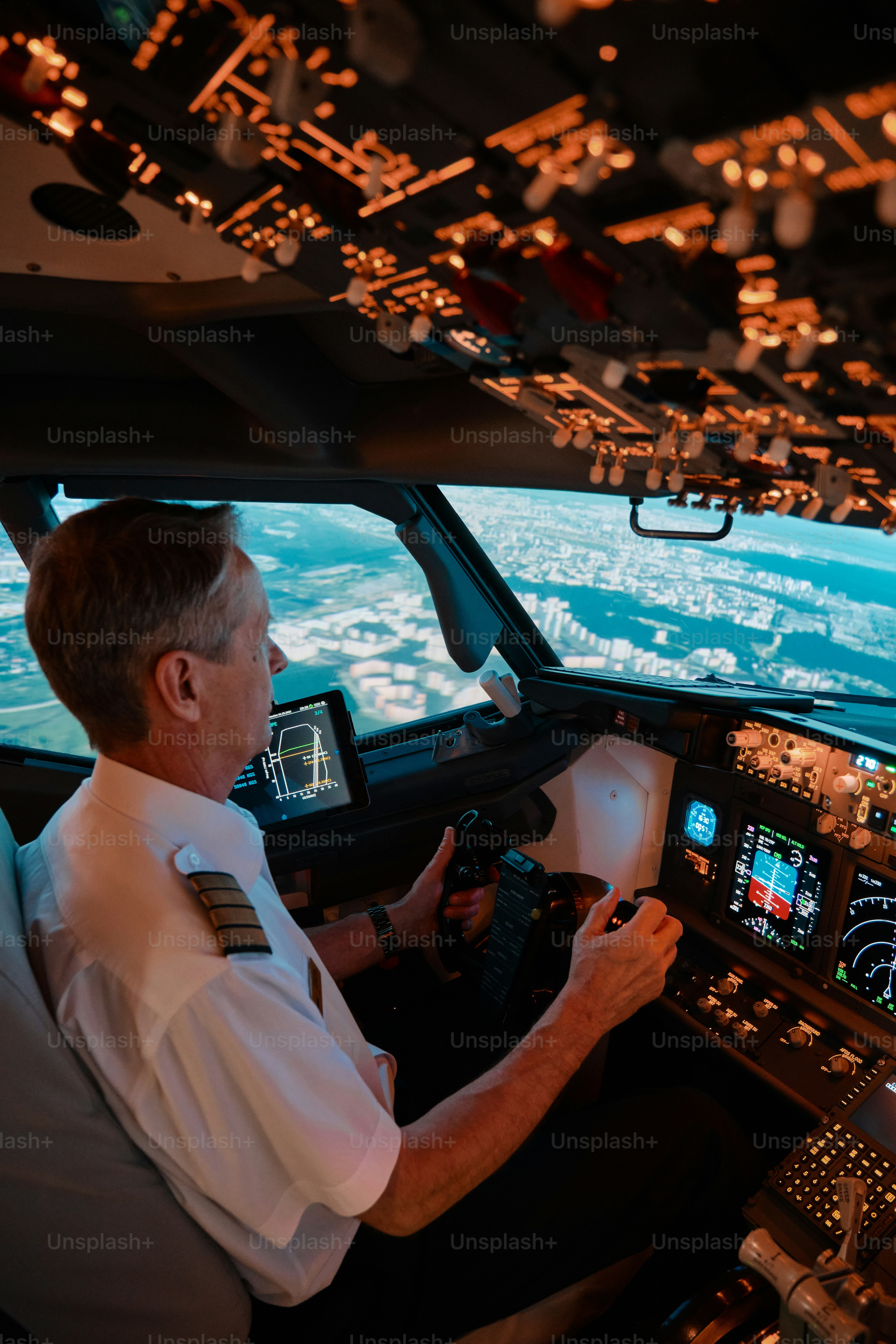 a pilot at work in the cockpit of a passenger airliner